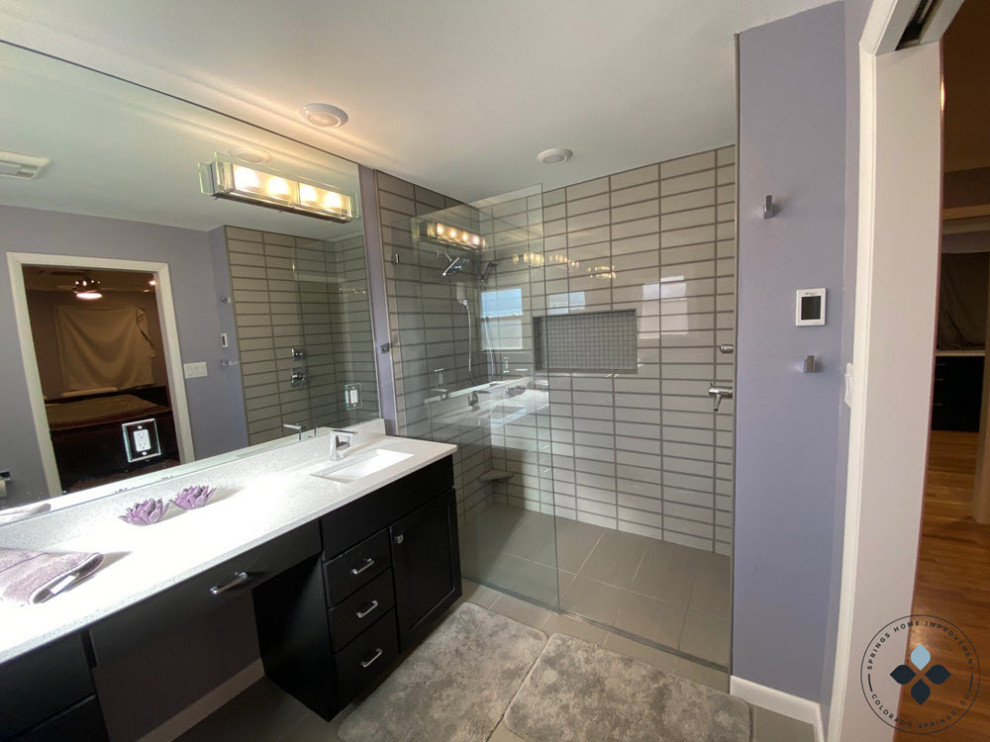 Design ideas for a large contemporary master bathroom in Denver with black cabinets, a curbless shower, beige tile, purple walls, ceramic floors, a drop-in sink, engineered quartz benchtops, beige floor, an open shower, white benchtops and a double vanity.