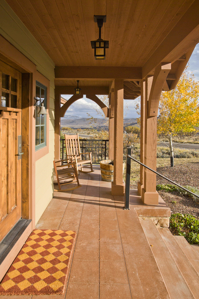 This is an example of a mid-sized country front yard verandah in Salt Lake City with stamped concrete and a roof extension.