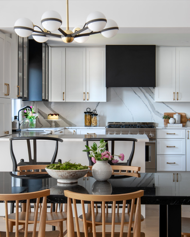 Inspiration for a mid-sized transitional u-shaped medium tone wood floor eat-in kitchen remodel with an undermount sink, shaker cabinets, white cabinets, quartz countertops, white backsplash, quartz backsplash, stainless steel appliances, a peninsula and white countertops