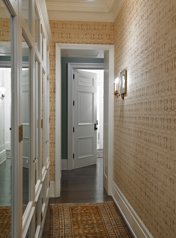 Design ideas for a mid-sized traditional hallway in New York with beige walls, dark hardwood floors and brown floor.