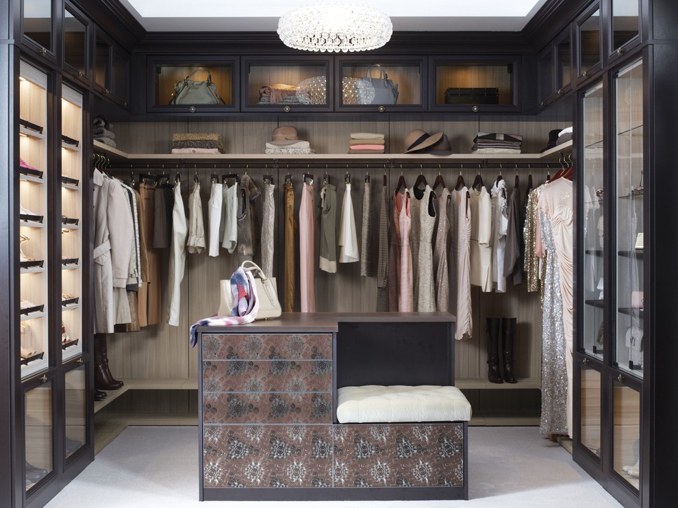 Inspiration for a mid-sized traditional women's dressing room in San Francisco with glass-front cabinets, dark wood cabinets and carpet.