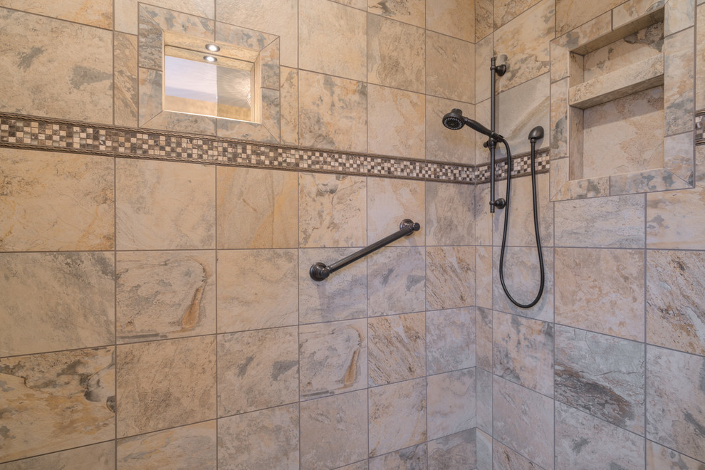 Inspiration for a mid-sized transitional master multicolored tile ceramic tile home design remodel with raised-panel cabinets, beige cabinets, a two-piece toilet, beige walls, an undermount sink and quartz countertops