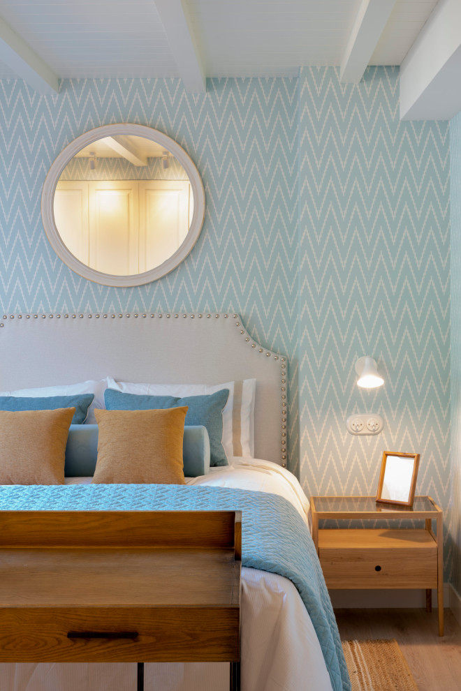 Diseño de habitación de invitados clásica renovada grande sin chimenea con paredes azules, suelo laminado, machihembrado, papel pintado y con escritorio