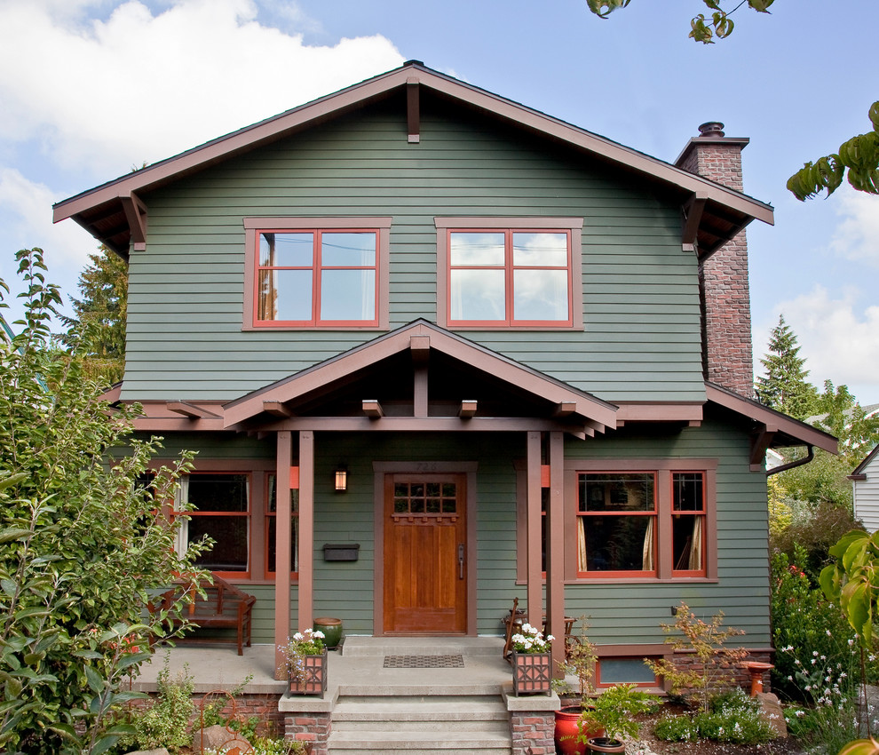 Mid-sized traditional two-storey green exterior in Seattle with wood siding and a gable roof.