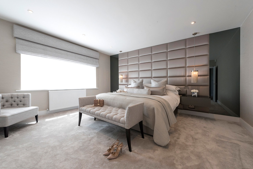 Transitional bedroom in Hertfordshire with beige walls, carpet and beige floor.