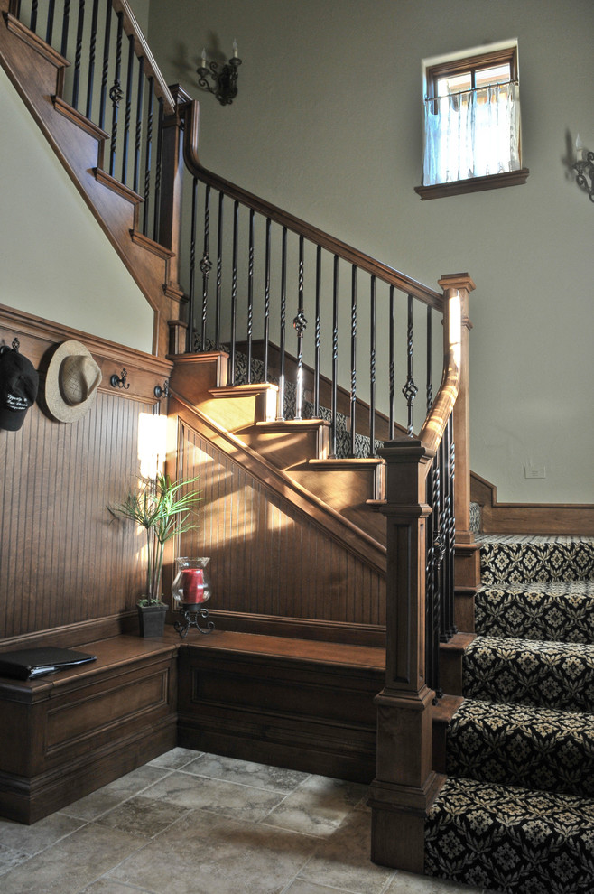 Photo of a large traditional wood l-shaped staircase in Oklahoma City with wood risers.