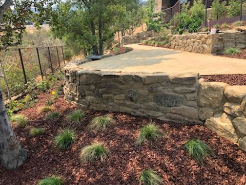 Stacked stone wall and plantings