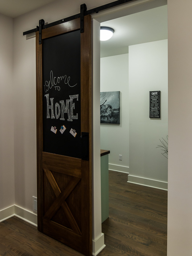Photo of a large country hallway in Minneapolis with grey walls and medium hardwood floors.