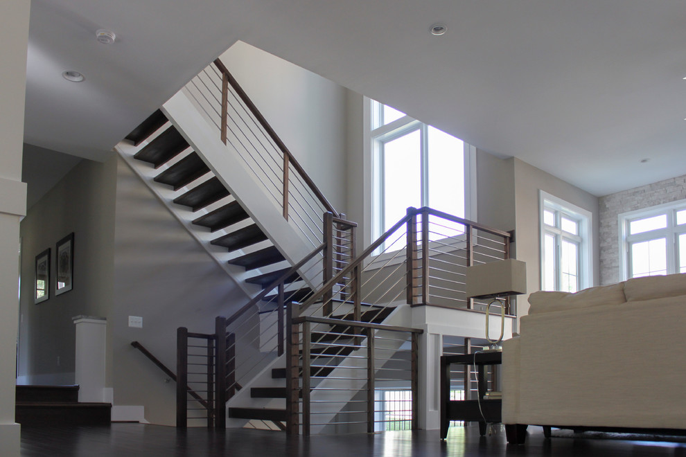 Design ideas for a large contemporary wood u-shaped staircase in DC Metro with mixed railing.