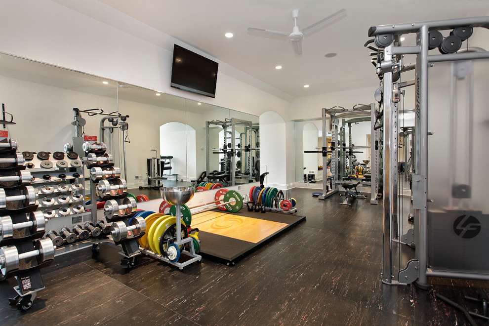 Large traditional home weight room in Chicago with white walls, vinyl floors and brown floor.