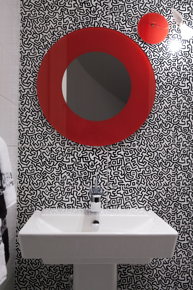 Inspiration for a small modern black and white tile, ceramic tile and white tile ceramic tile powder room remodel in New York with a one-piece toilet, white walls and a pedestal sink