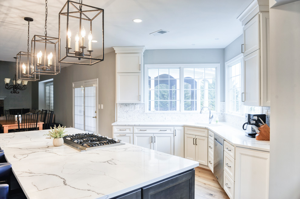 Example of a huge transitional galley light wood floor and brown floor eat-in kitchen design in DC Metro with an undermount sink, beaded inset cabinets, white cabinets, quartzite countertops, white backsplash, marble backsplash, stainless steel appliances, an island and white countertops