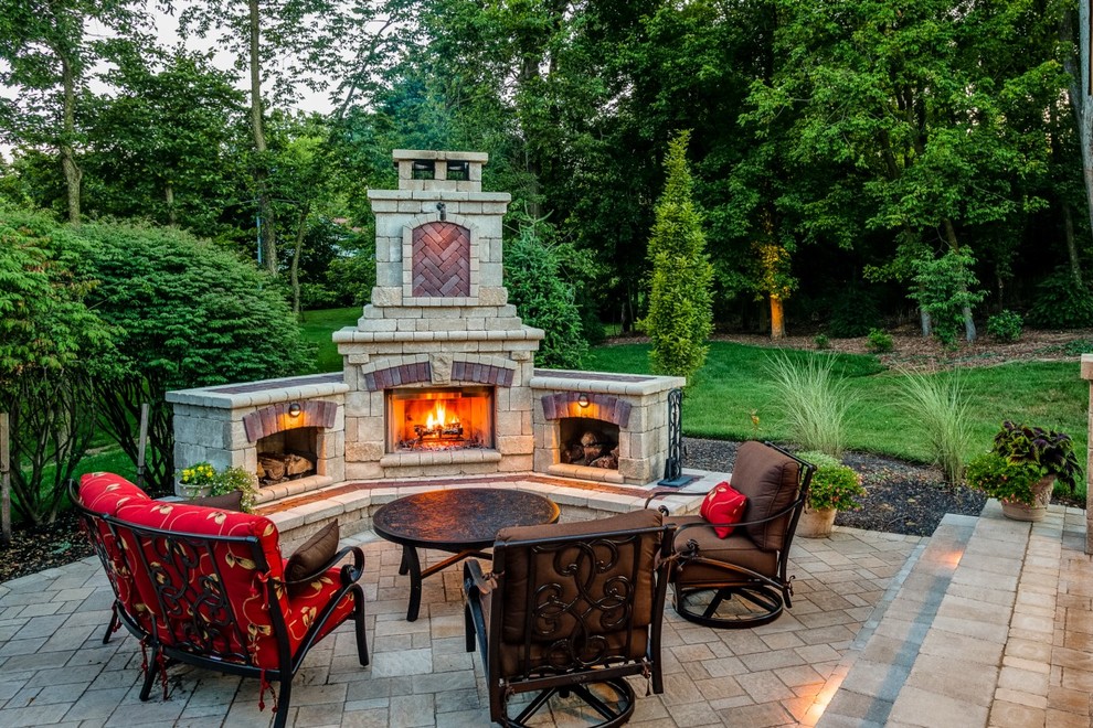 Photo of a traditional patio in Other with brick pavers and a fire feature.