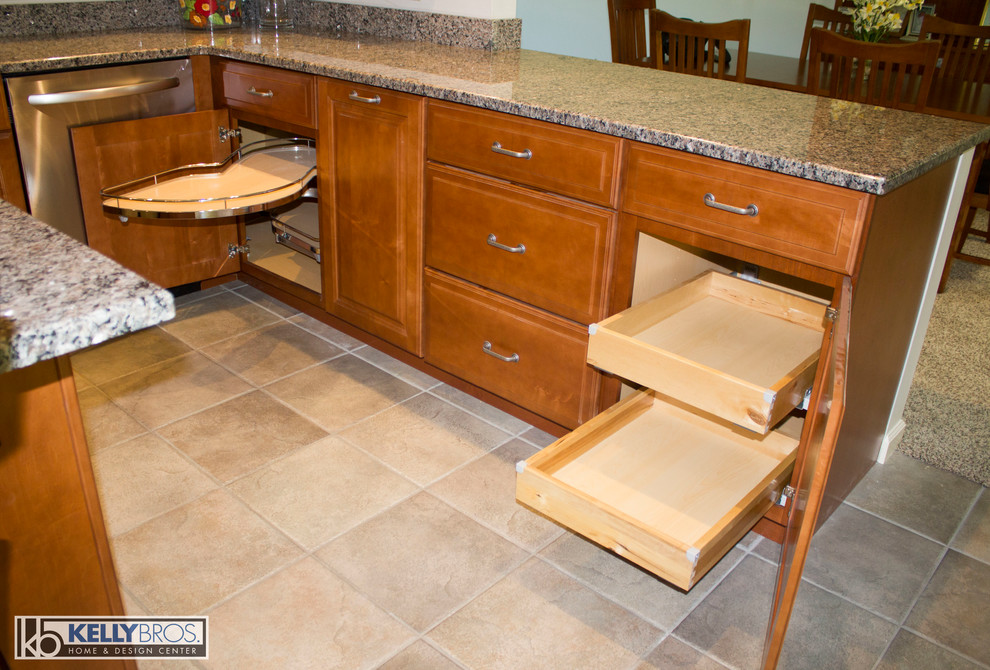 Home design - large transitional u-shaped ceramic tile home design idea in Cincinnati with a double-bowl sink, raised-panel cabinets, medium tone wood cabinets, granite countertops, stainless steel appliances and an island