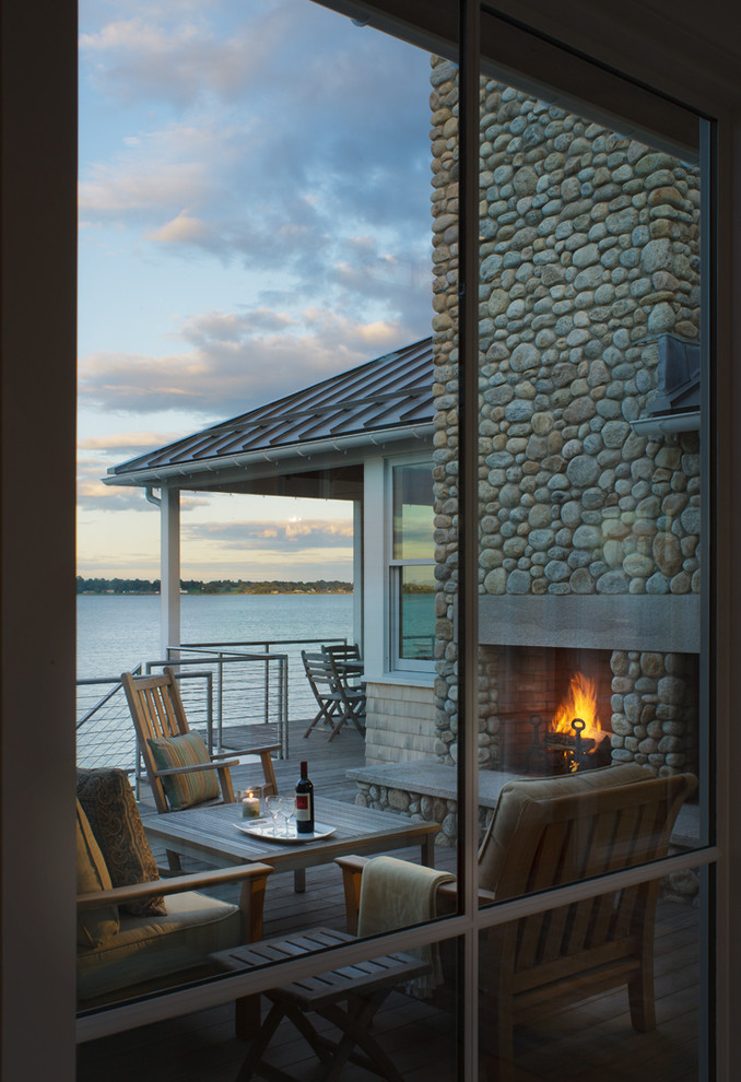 This is an example of a contemporary patio in Providence with a fire feature and decking.