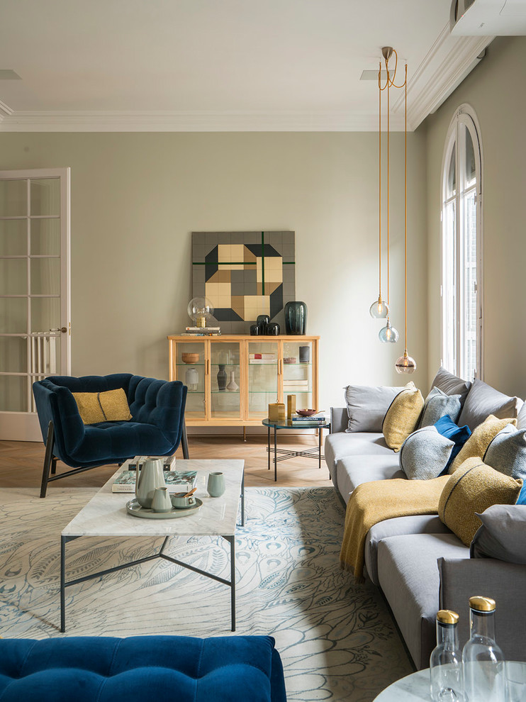 Large mediterranean formal enclosed living room in Barcelona with beige walls, medium hardwood floors, a plaster fireplace surround, no tv and beige floor.