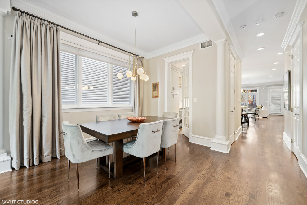 This is an example of a mid-sized traditional dining room in Chicago with beige walls and dark hardwood floors.