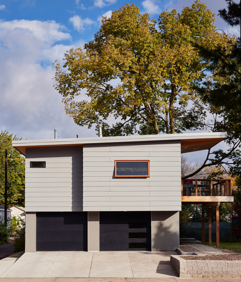 Midcentury grey house exterior in Minneapolis with a shed roof.