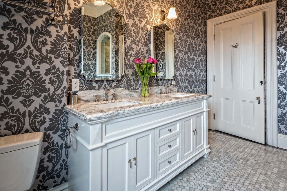 Inspiration for a mid-sized traditional kids bathroom in Ottawa with recessed-panel cabinets, white cabinets, a claw-foot tub, an alcove shower, a two-piece toilet, white tile, stone tile, multi-coloured walls, marble floors, an undermount sink and zinc benchtops.