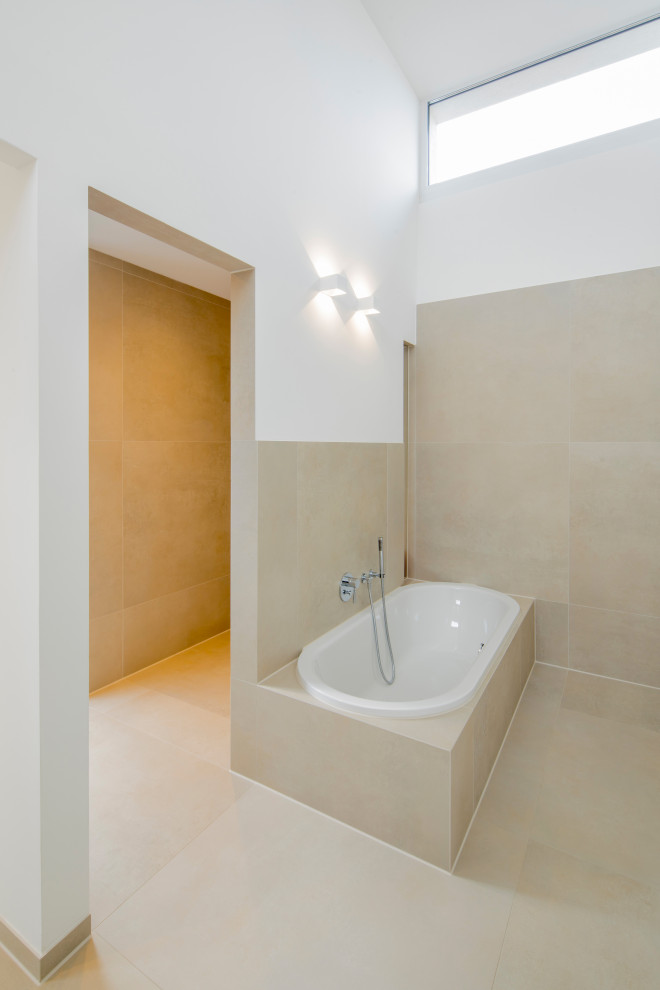 Large contemporary master bathroom in Dusseldorf with a drop-in tub, a curbless shower, ceramic tile, an open shower, flat-panel cabinets, white cabinets, a two-piece toilet, beige tile, white walls, ceramic floors, a vessel sink, beige floor, brown benchtops, a shower seat and a double vanity.