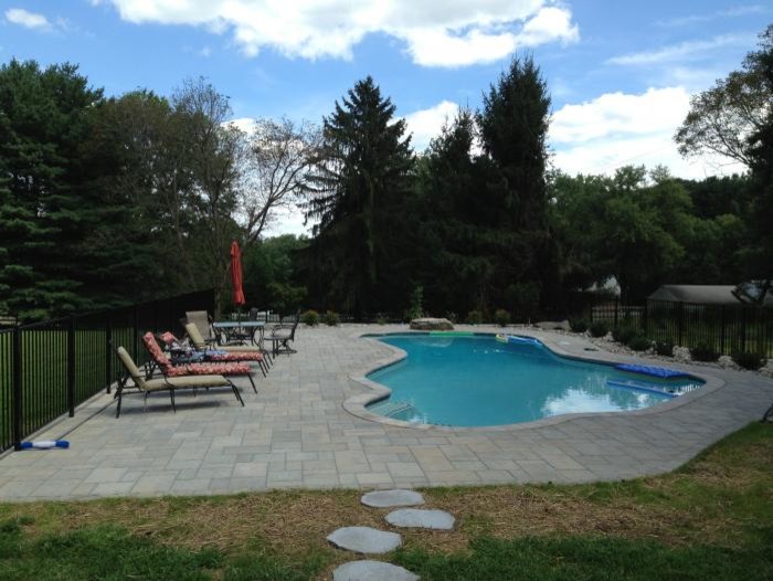 Pool fountain - large rustic backyard stone and custom-shaped natural pool fountain idea in Baltimore