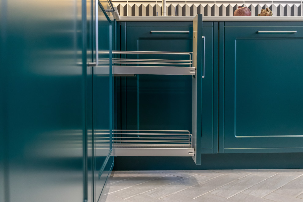 Small u-shaped separate kitchen in Other with an integrated sink, raised-panel cabinets, blue cabinets, solid surface benchtops, multi-coloured splashback, ceramic splashback, coloured appliances, no island and beige benchtop.