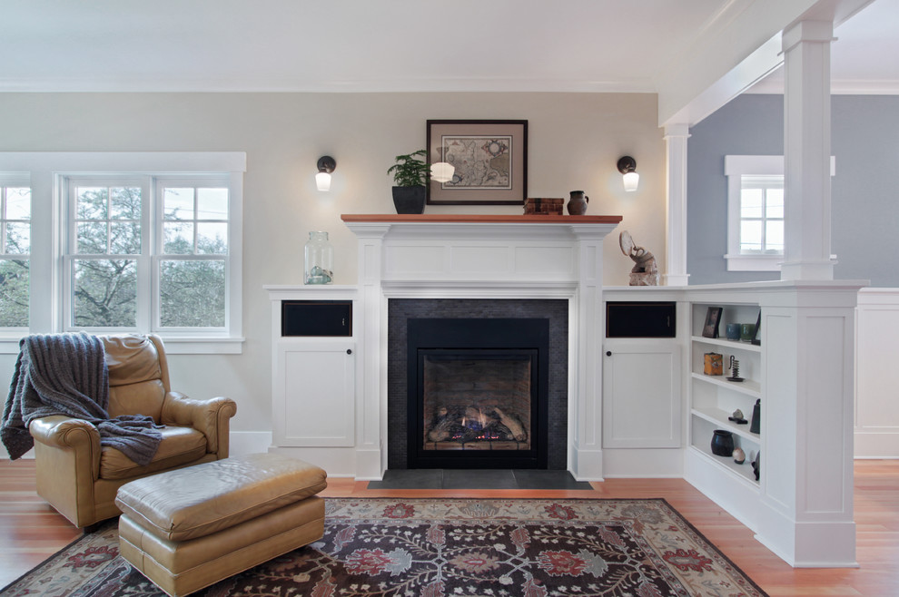 Mid-sized traditional open concept living room in Seattle with beige walls, a standard fireplace, medium hardwood floors, a tile fireplace surround and brown floor.