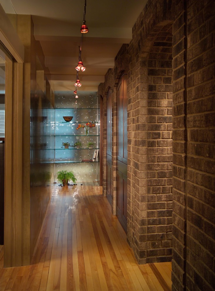 Inspiration for a mid-sized eclectic hallway in Minneapolis with medium hardwood floors.