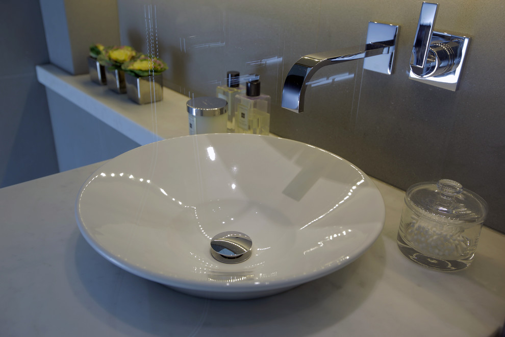 Inspiration for a small contemporary master bathroom in London with a vessel sink and marble benchtops.