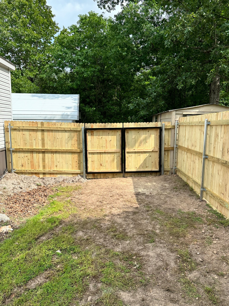 Photo of a small arts and crafts backyard partial sun garden in Other with with a gate and a wood fence.