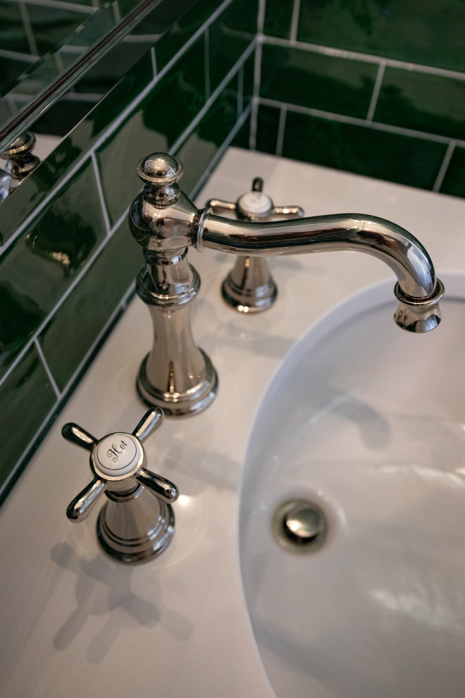 Example of a mid-sized transitional green tile and ceramic tile mosaic tile floor, multicolored floor and wallpaper powder room design with a one-piece toilet, green walls, an undermount sink, solid surface countertops and white countertops