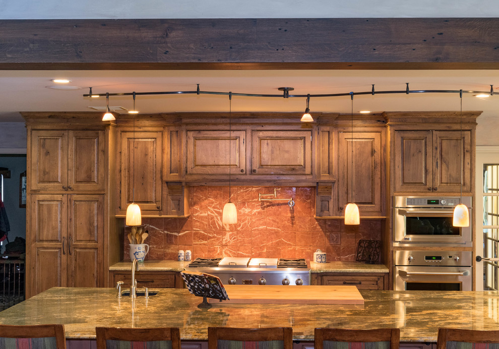 Inspiration for a large rustic u-shaped eat-in kitchen remodel with distressed cabinets, granite countertops, stone slab backsplash, stainless steel appliances and an island