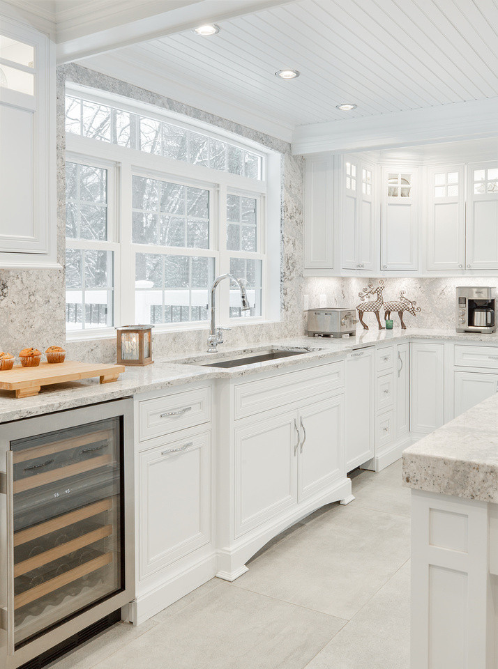 Example of a large transitional l-shaped ceramic tile and gray floor eat-in kitchen design with an undermount sink, beaded inset cabinets, white cabinets, quartz countertops, multicolored backsplash, quartz backsplash, stainless steel appliances, an island and multicolored countertops