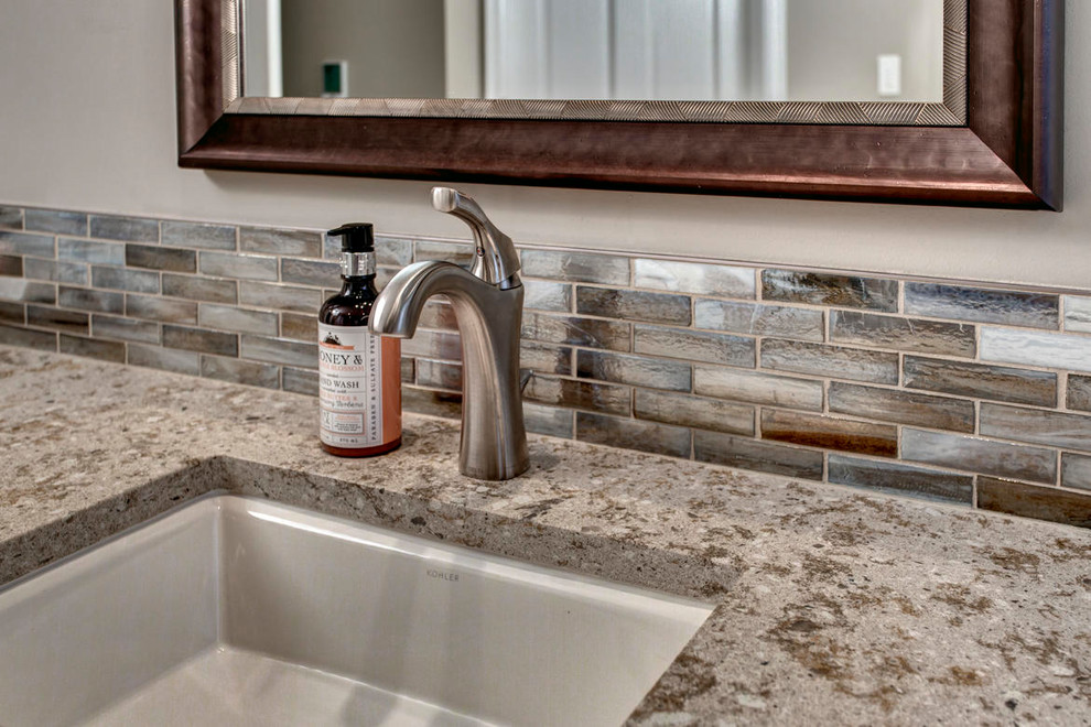 Large transitional master multicolored tile and matchstick tile pebble tile floor freestanding bathtub photo in Seattle with shaker cabinets, dark wood cabinets, a two-piece toilet, beige walls, an undermount sink and quartz countertops