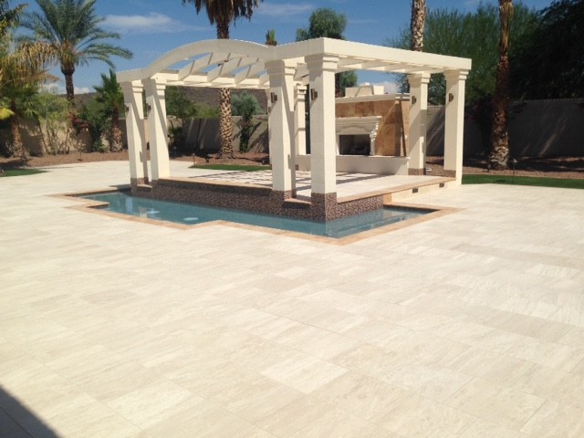 Design ideas for an expansive traditional backyard patio in Phoenix with natural stone pavers.