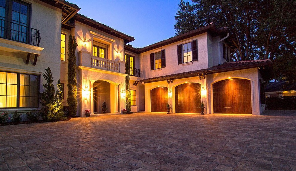 Inspiration for a large mediterranean two-storey stucco beige exterior in Tampa with a hip roof.