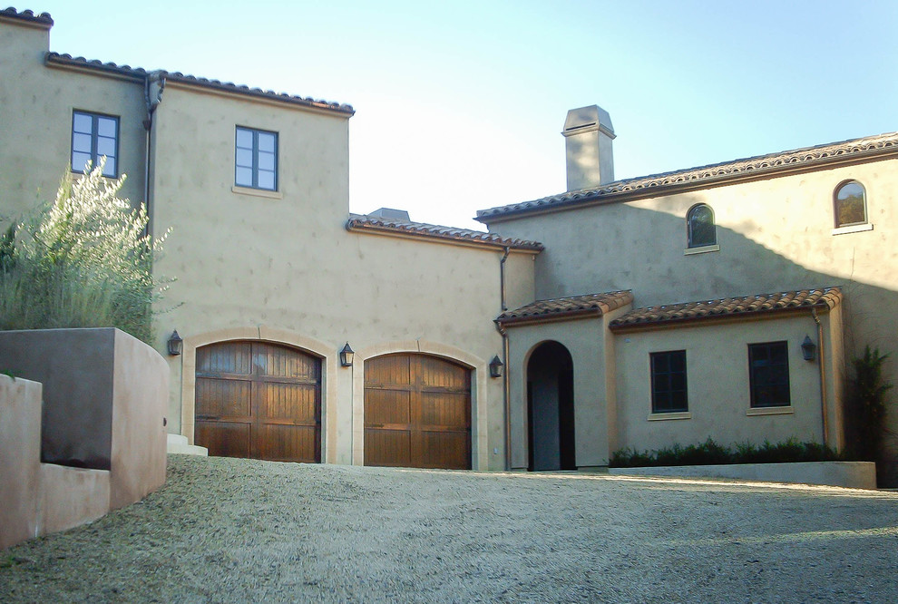 Large mediterranean two-storey adobe beige exterior in San Francisco with a hip roof.