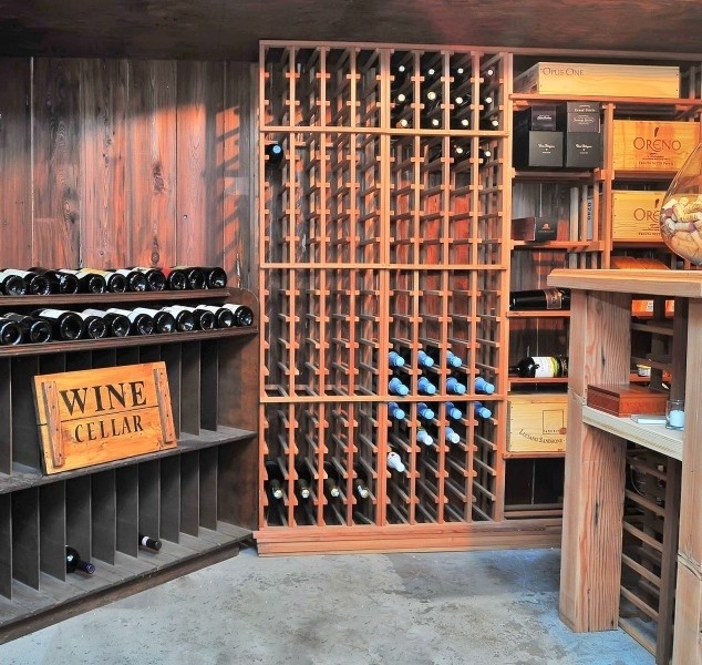 Inspiration for a mid-sized transitional wine cellar in New York with concrete floors and storage racks.