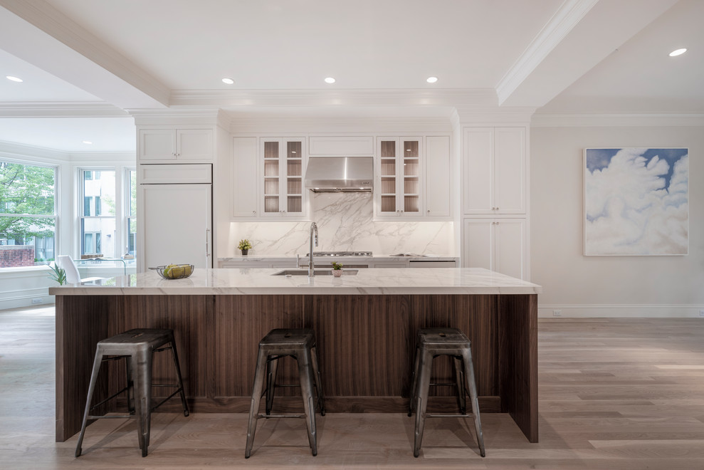 Inspiration for a transitional kitchen in Boston with an undermount sink, shaker cabinets, white cabinets, solid surface benchtops, grey splashback, stainless steel appliances, light hardwood floors, with island, grey benchtop and coffered.