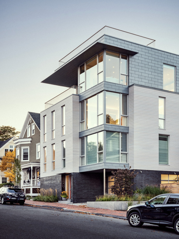 This is an example of a multi-coloured contemporary house exterior in Portland Maine with four floors and a flat roof.