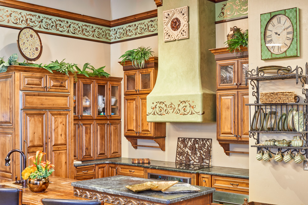 Eat-in kitchen - mid-sized transitional u-shaped eat-in kitchen idea in Austin with an integrated sink, raised-panel cabinets, medium tone wood cabinets, granite countertops, paneled appliances and an island