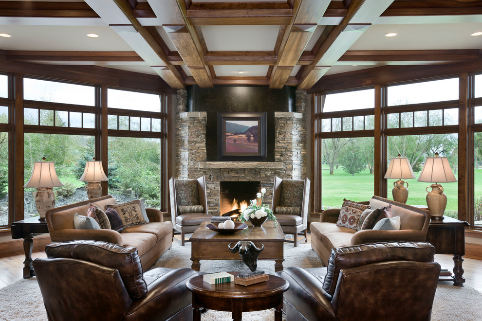 Country formal living room in Other with dark hardwood floors, a standard fireplace and a stone fireplace surround.