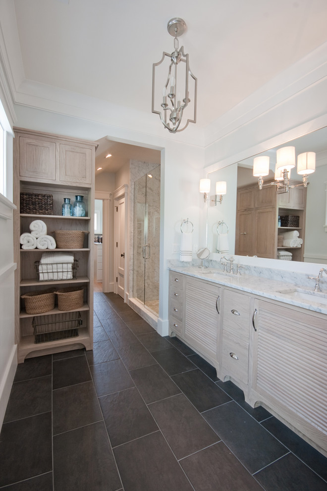 Inspiration for a mid-sized tropical master bathroom in Charleston with an undermount sink, louvered cabinets, light wood cabinets, marble benchtops, an alcove shower, black tile, stone tile, white walls and slate floors.