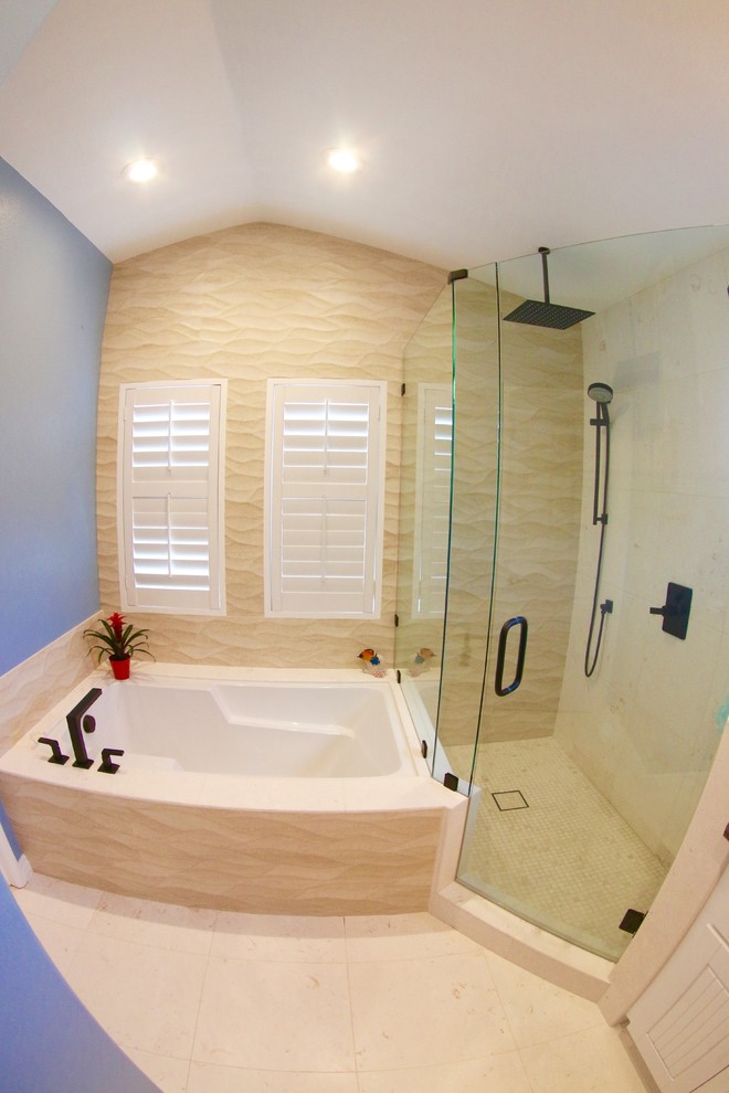 Mid-sized beach style master bathroom in San Diego with an integrated sink, flat-panel cabinets, white cabinets, granite benchtops, a corner tub, a corner shower, a two-piece toilet, beige tile, ceramic tile, blue walls and porcelain floors.