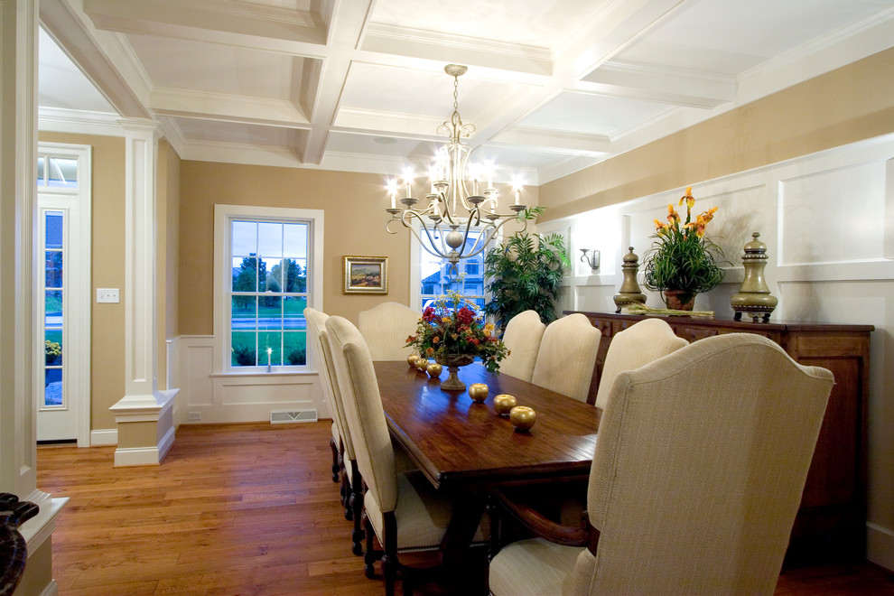 Photo of a large traditional separate dining room in Other with beige walls and light hardwood floors.