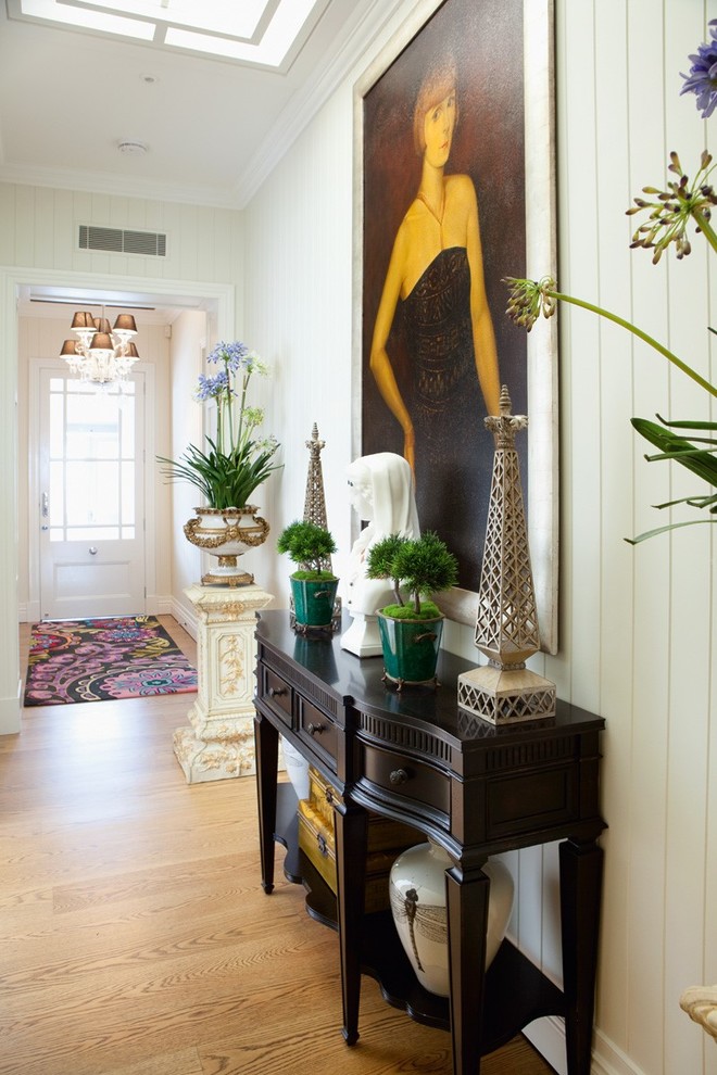 Design ideas for a transitional hallway in Brisbane with white walls and light hardwood floors.