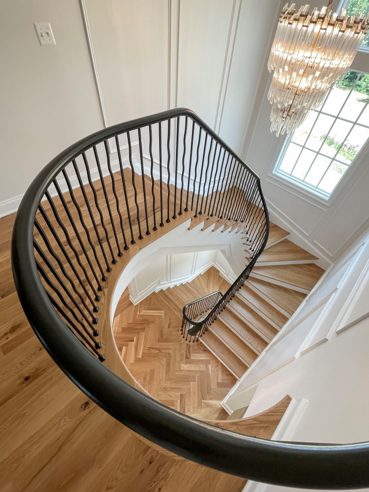 Design ideas for a large transitional wood floating staircase in DC Metro with painted wood risers, mixed railing and decorative wall panelling.