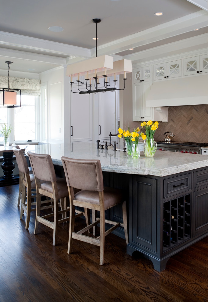 Example of a transitional l-shaped eat-in kitchen design in DC Metro with a farmhouse sink, raised-panel cabinets, gray cabinets, granite countertops, gray backsplash and stainless steel appliances