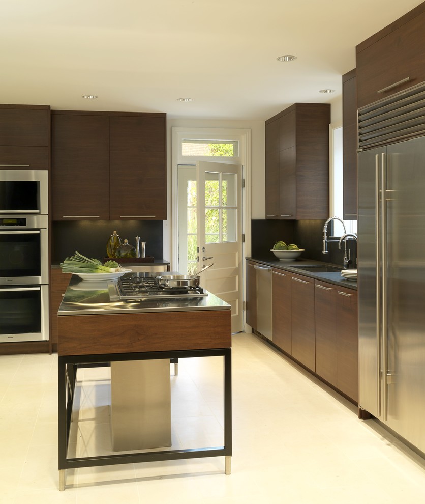 Inspiration for a contemporary l-shaped separate kitchen in St Louis with an undermount sink, flat-panel cabinets, dark wood cabinets, granite benchtops, black splashback, stainless steel appliances, stone slab splashback, limestone floors and with island.