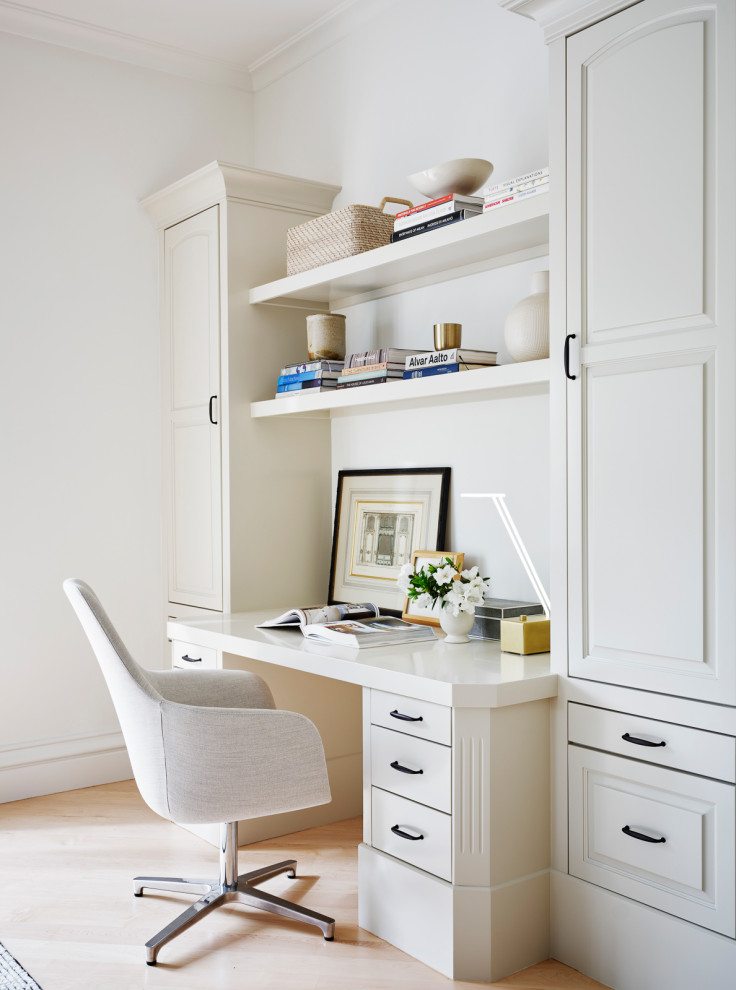 Example of a small classic built-in desk light wood floor and brown floor home office design in San Francisco with white walls and no fireplace